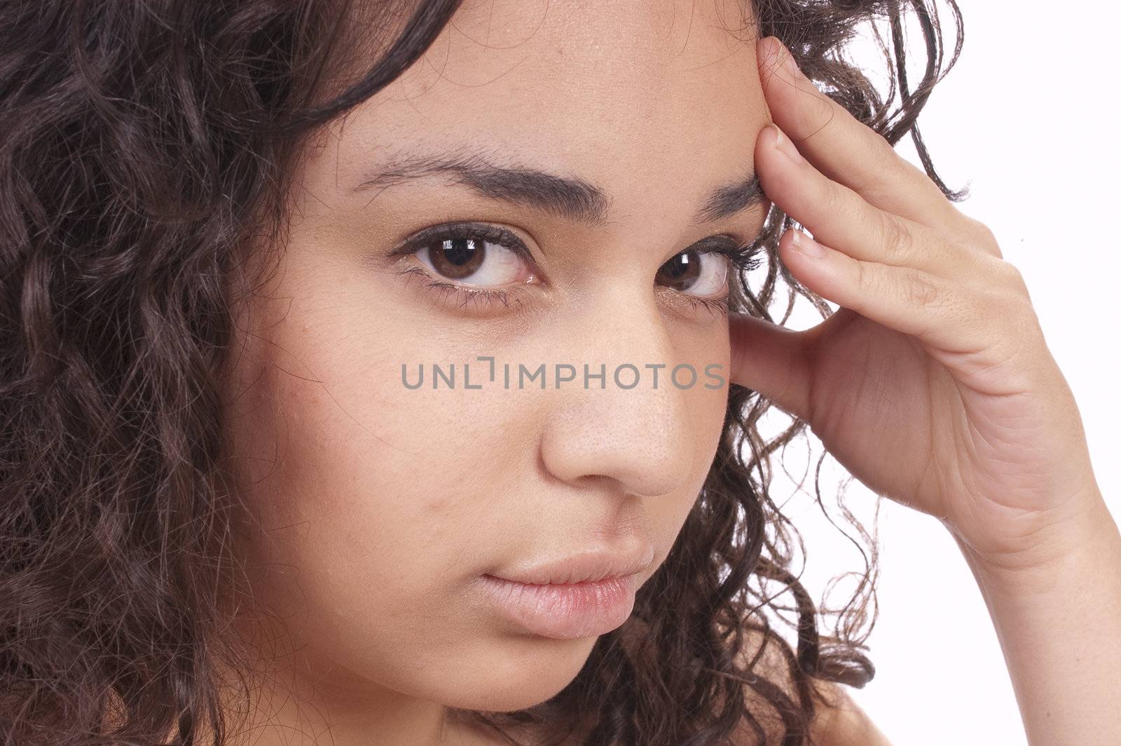 Young Hispanic girl with headache resting head in hand and isolated on white
