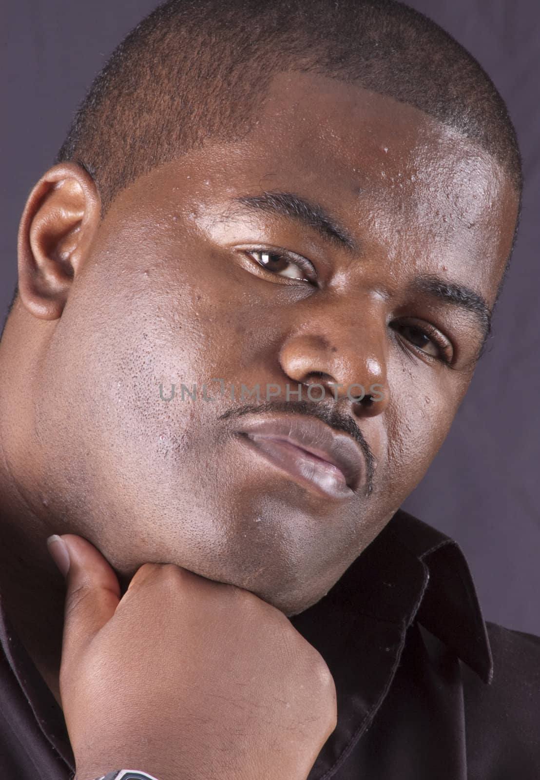 closeup of a young african american man with a pencil thin mustache