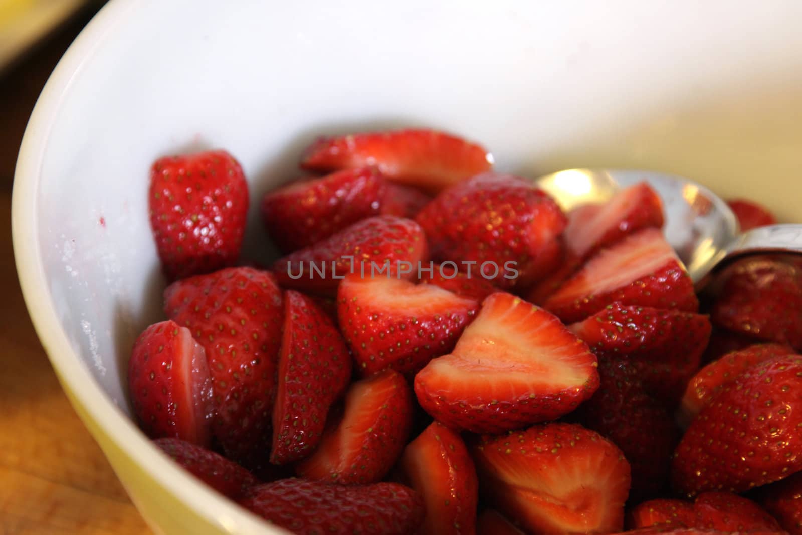 A bowl of freshly cut strawberries.