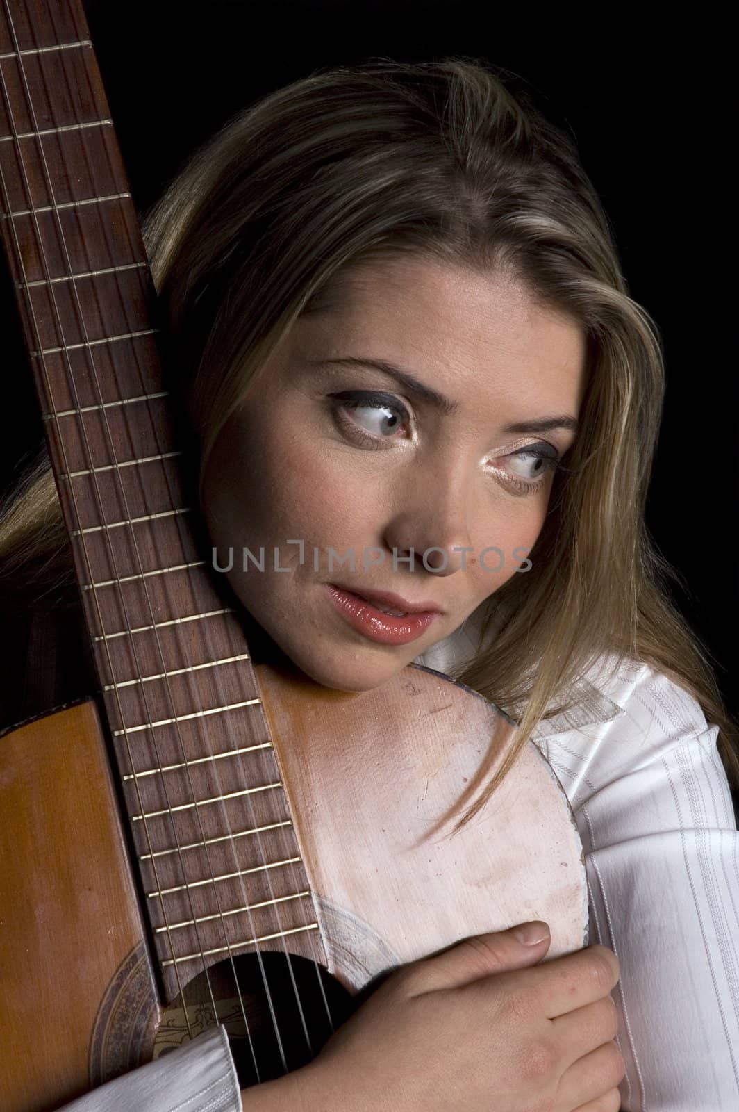 female guitarist caressing guitar in close up isolated on black 