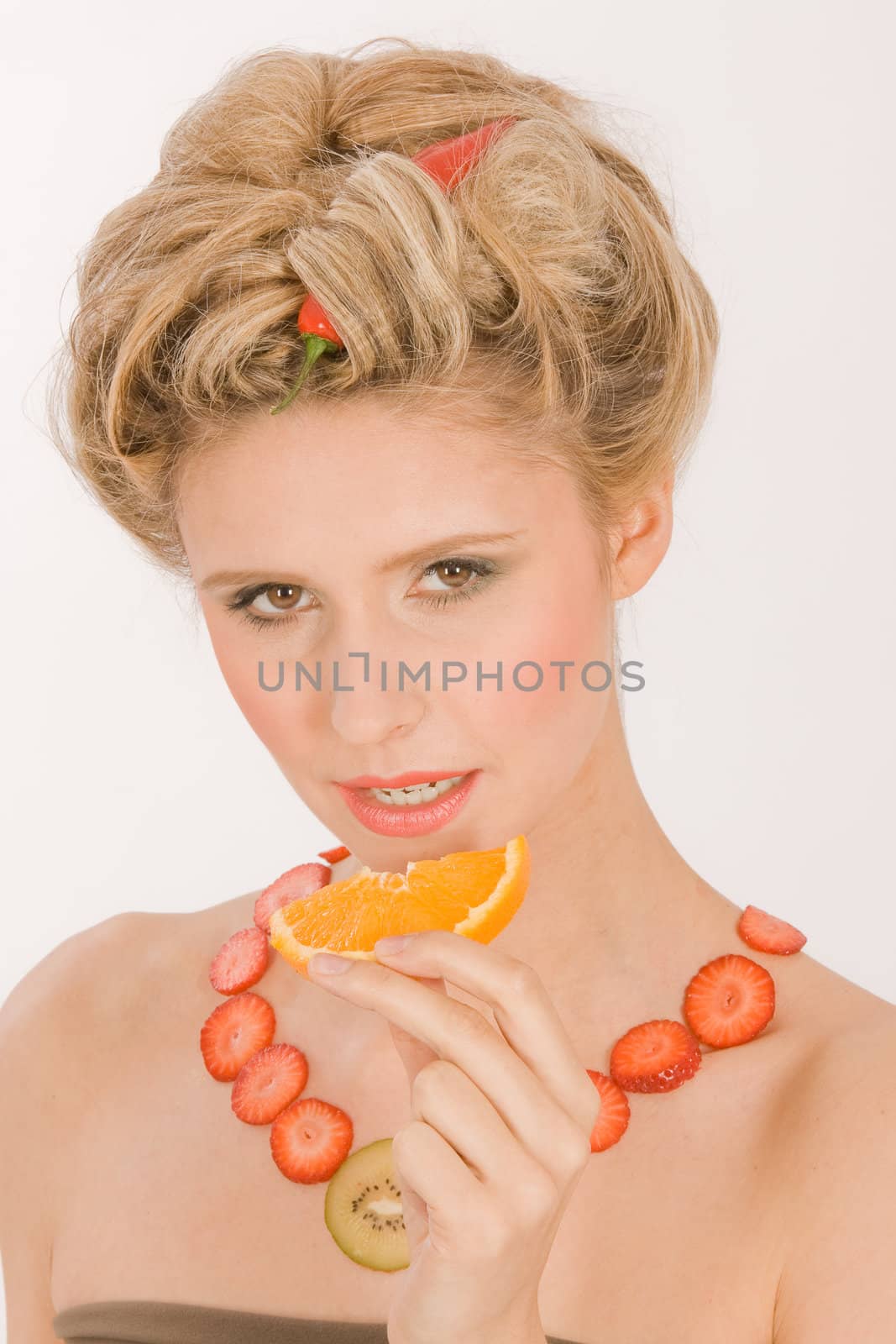 Attractive young blond woman with strawberry-kiwi-chain by STphotography