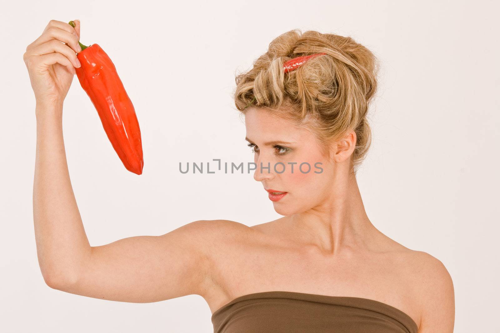 Woman with chili pepper in your hand and in her hair
