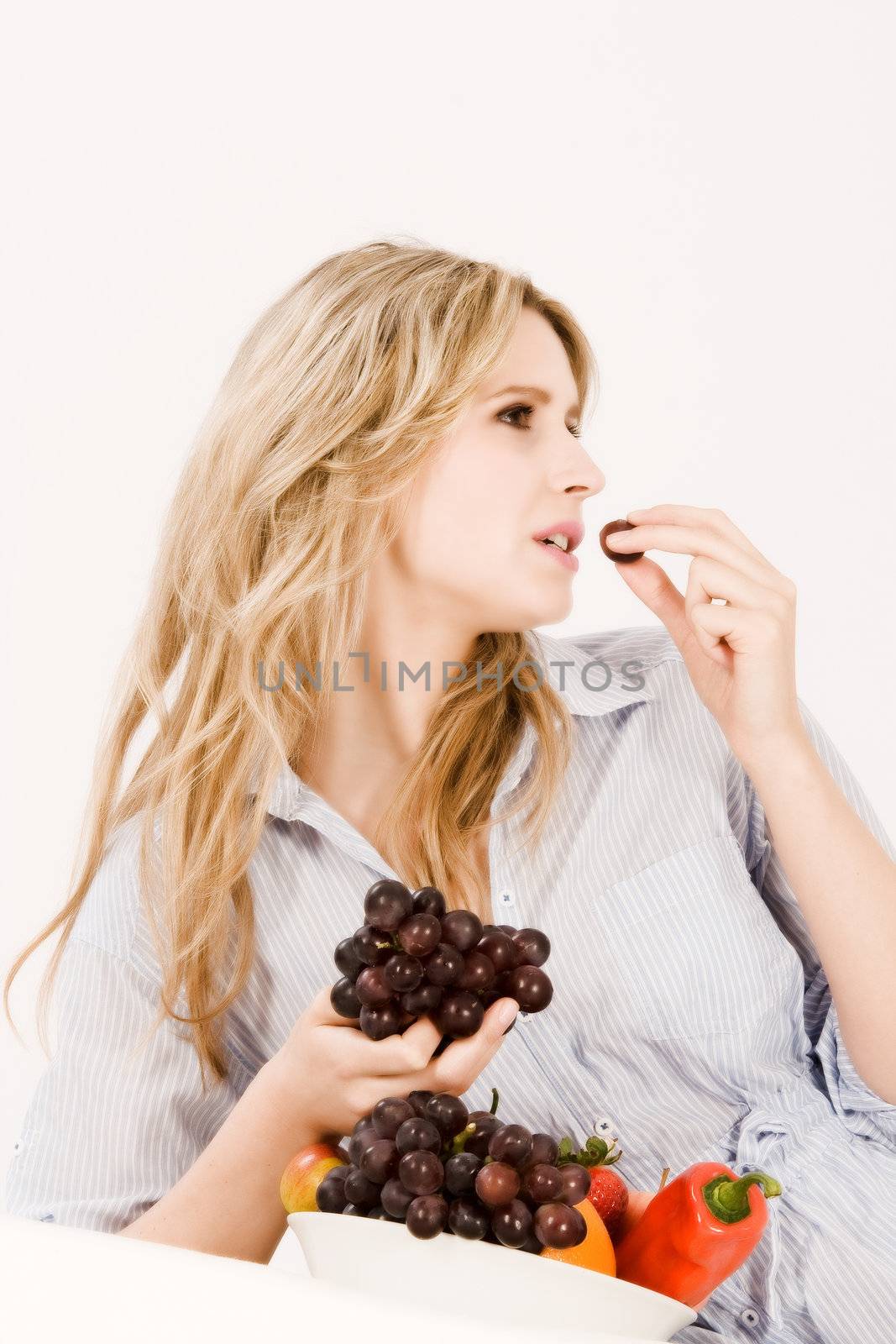 Young woman enjoys in your fruit bowl are