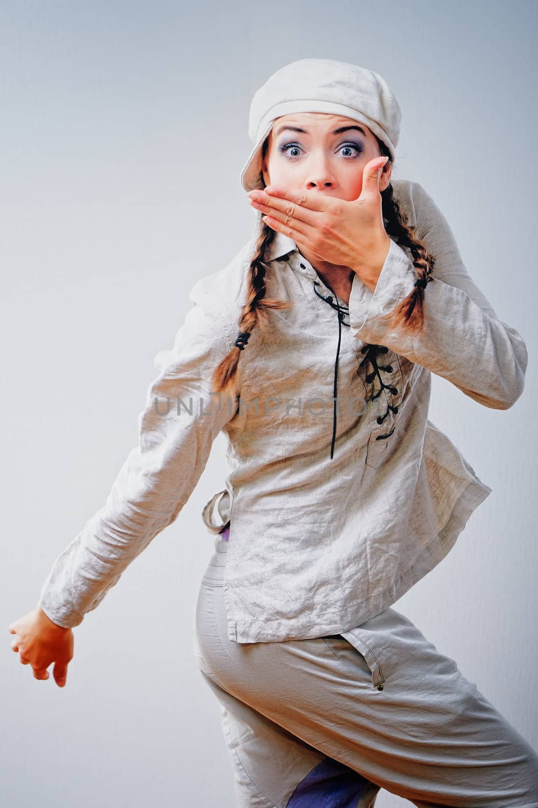 Surprised cute young woman in white suit