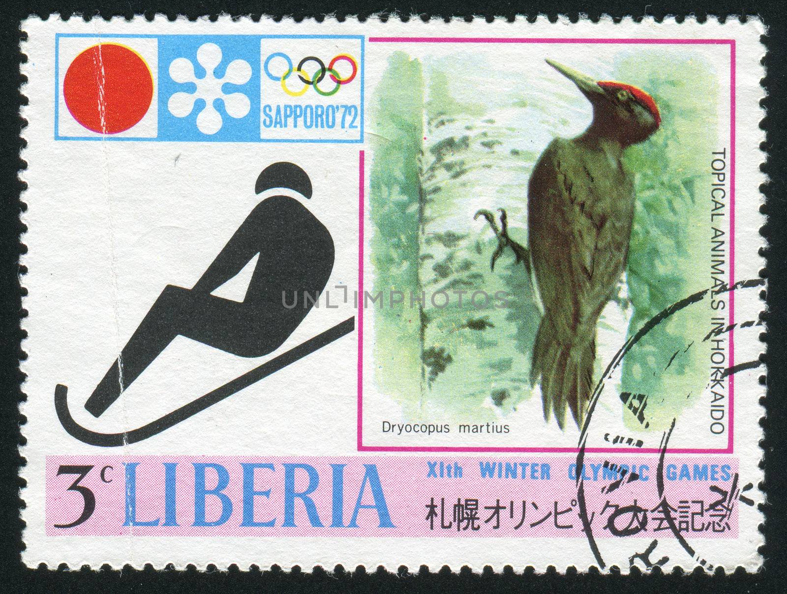 LIBERIA - CIRCA 1971: Sapporo 72 Emblem: Sledding and black woodpecker, circa 1971.