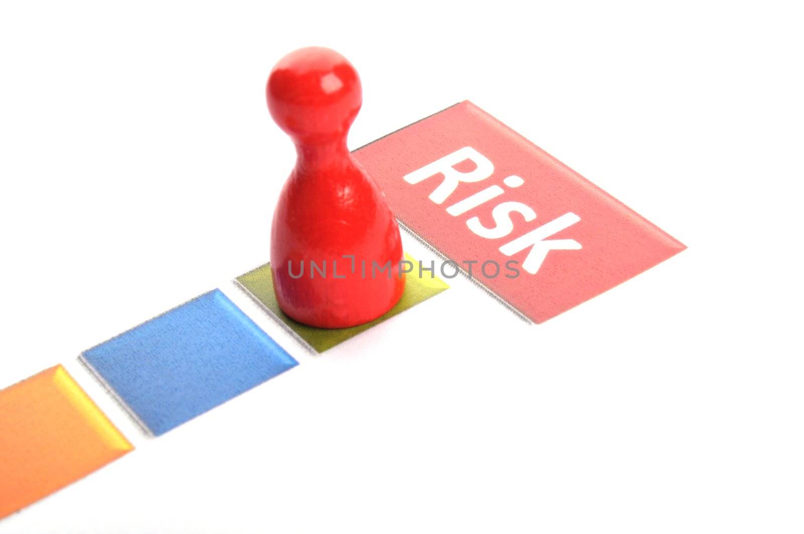 risk business concept with red pawn on white