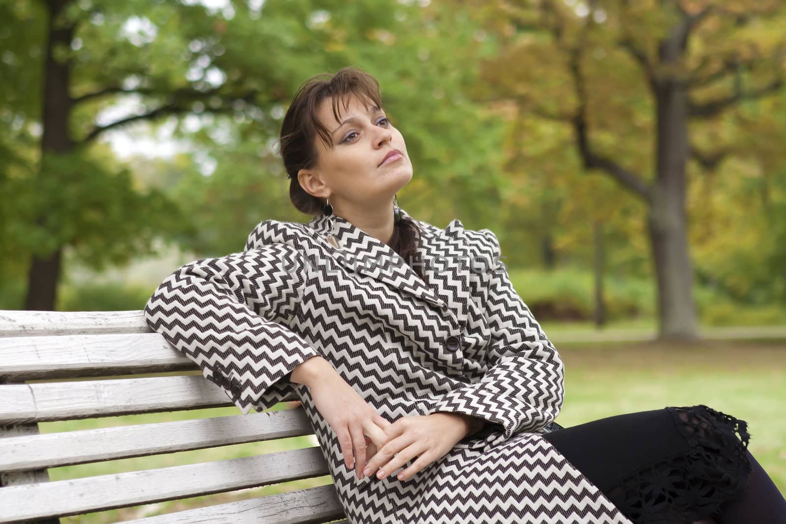 young girl relaxing in autumn park by michey