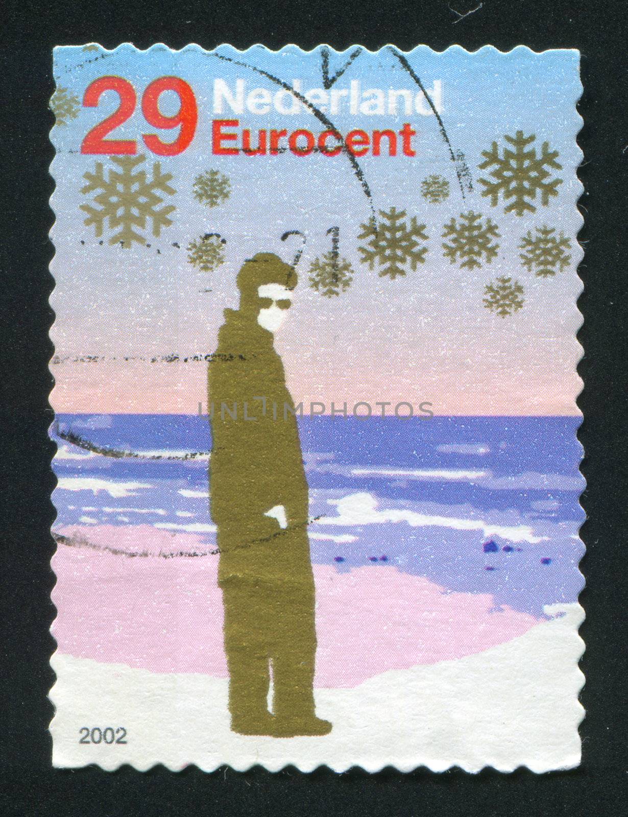 NETHERLANDS - CIRCA 2004: Person with sunglasses standing near shore, circa 2004.
