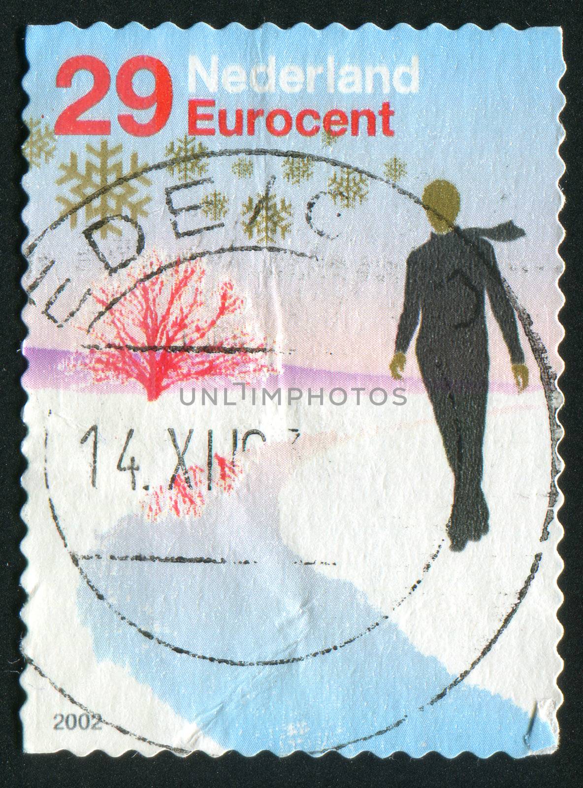 NETHERLANDS - CIRCA 2004: Red tree, person in black, circa 2004.