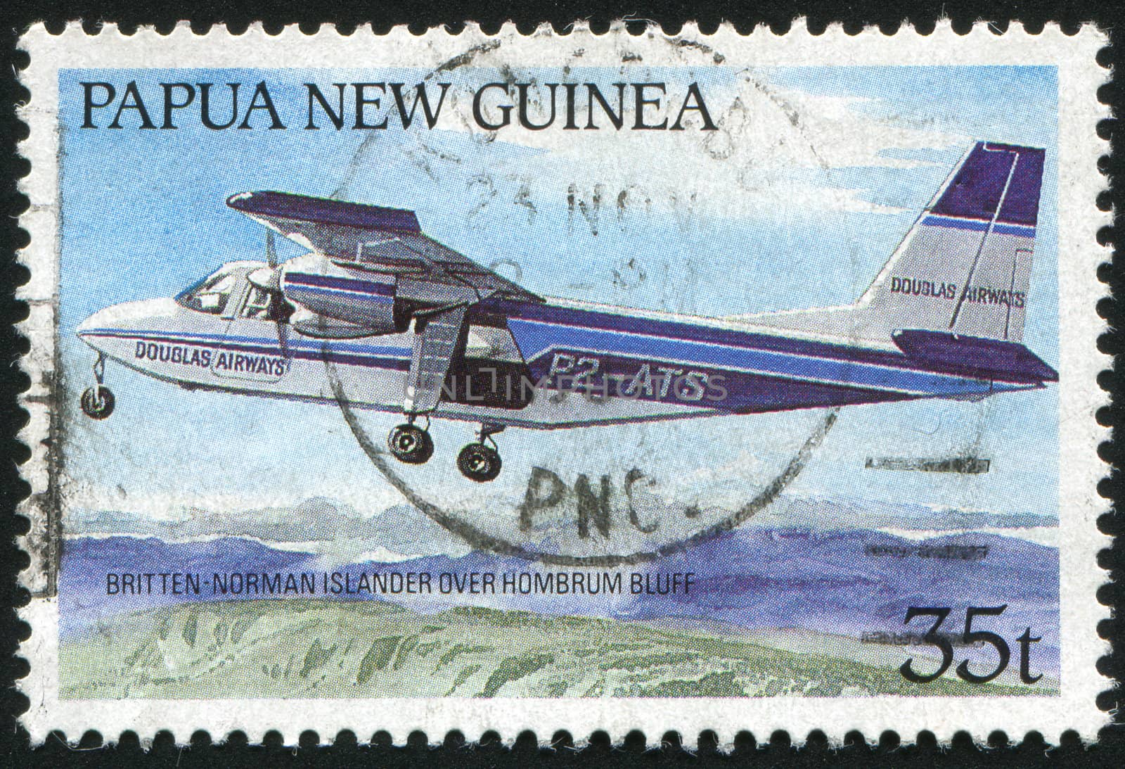 PAPUA NEW GUINEA - CIRCA 1970: The plane flies over mountains, circa 1970.