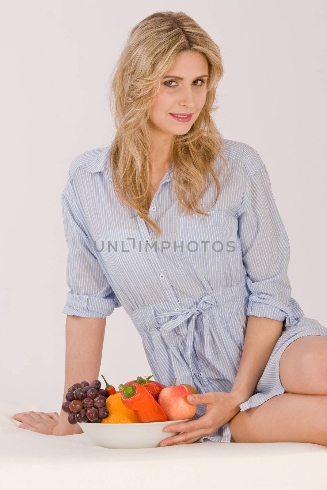 Young woman sitting with a bowl of fruit