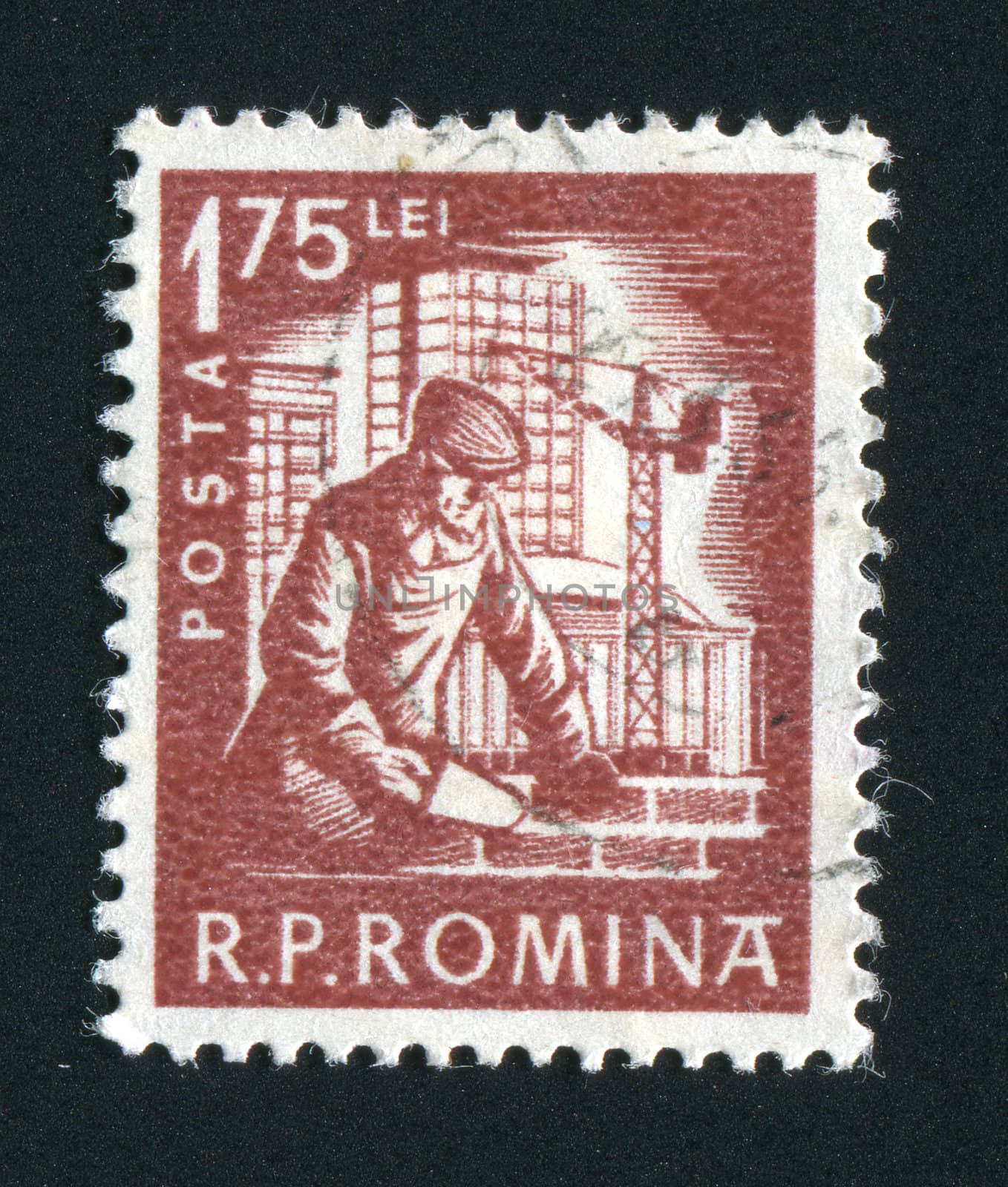ROMANIA - CIRCA 1957: The worker builds the big house, circa 1957.