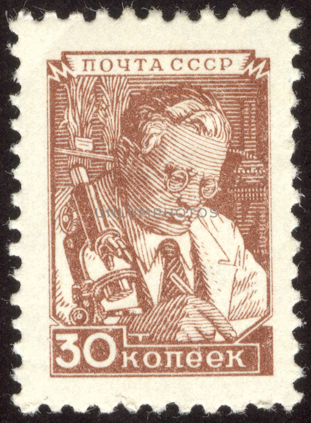 The scanned stamp. The Soviet stamp. Scientific work. The microscope stands on a table.