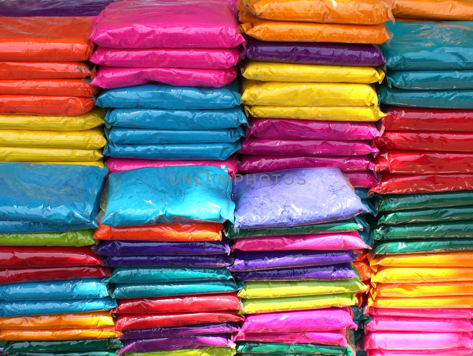 A background of plastic packets containing colorful powder for the traditional celebration of holi festival in India.