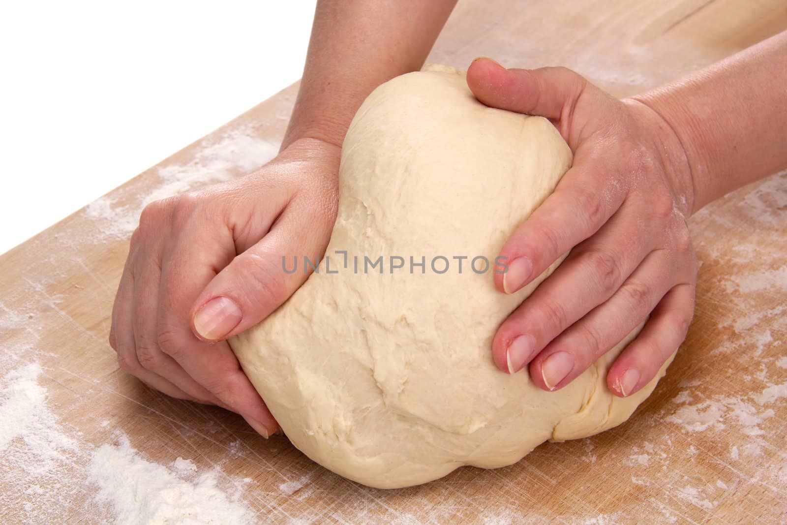 Women's hands kneading dough for baking

