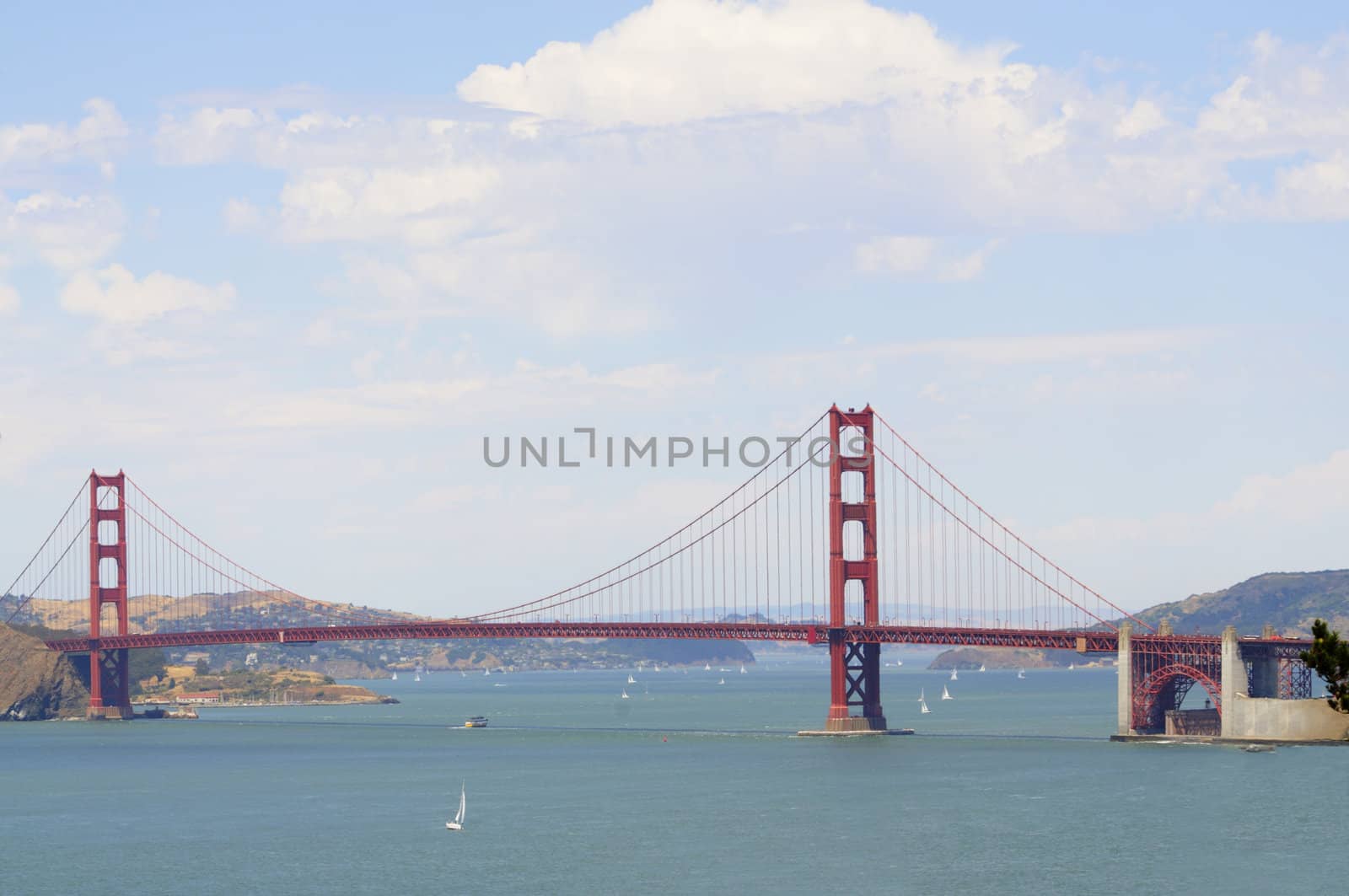 Golden gate bridge from the Presidio, with sail boats and a cruise ship in the bay