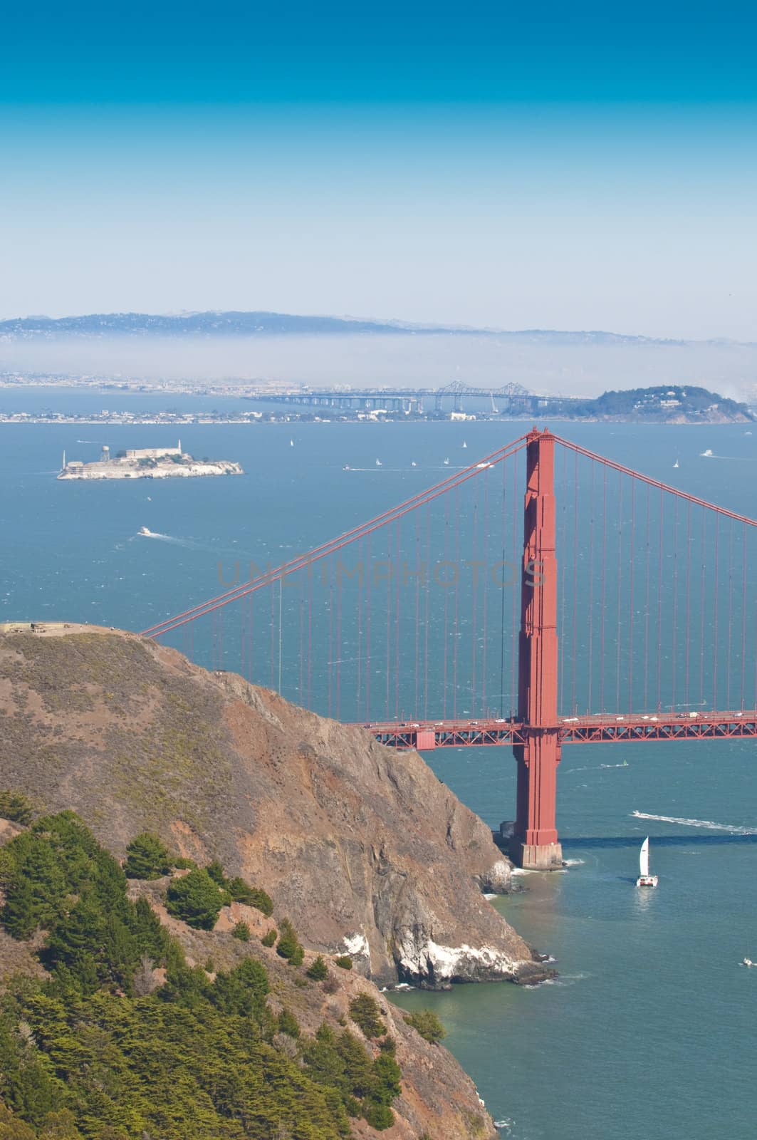 Tower on Golden gate bridge, alcatraz, Oakland and Bay bridge in the distance