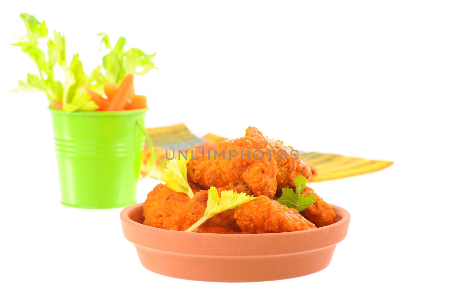 Hot and spicy chicken wings served with crisp vegetables.