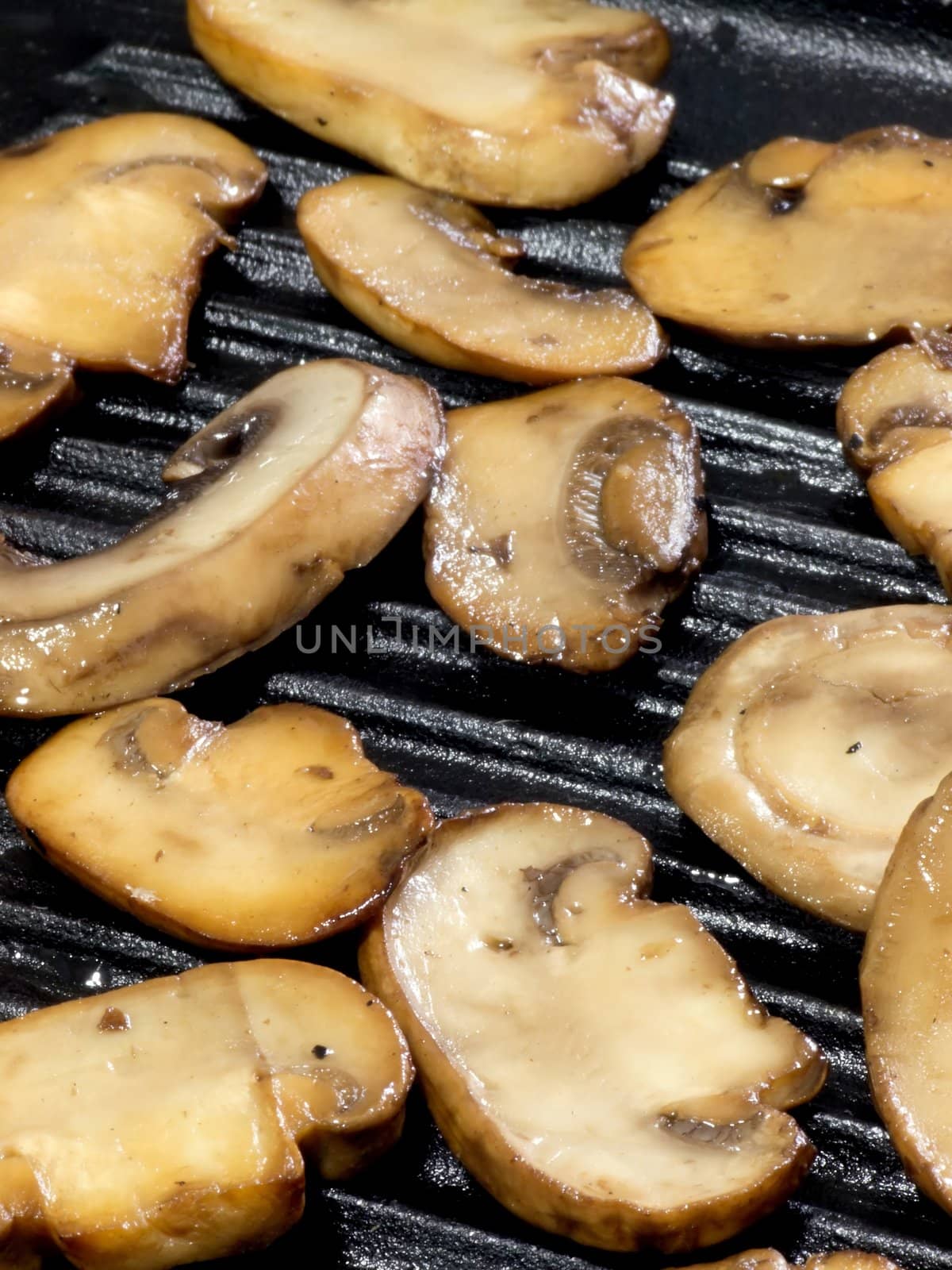 close up of sauteed mushrooms on a grill