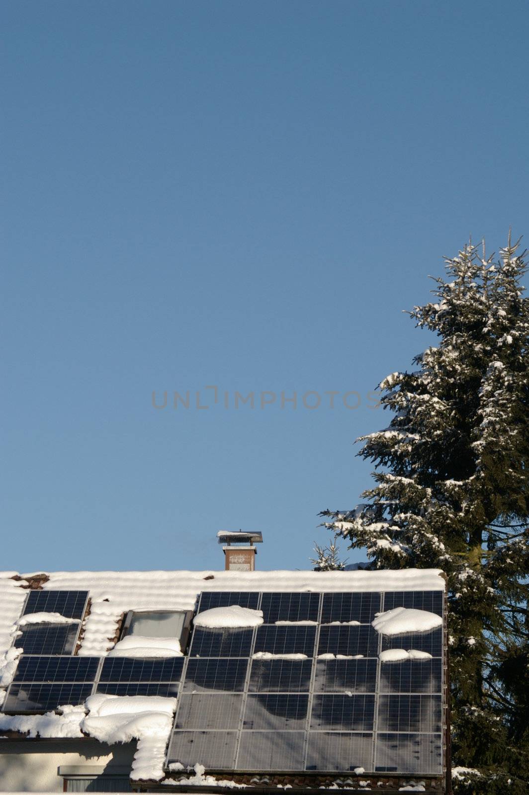 solar cells on a snowy roof in winter