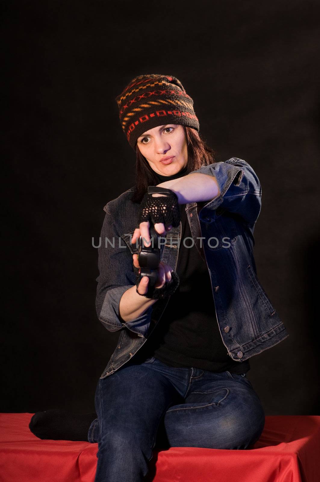 woman gamer with joystick  on darken background