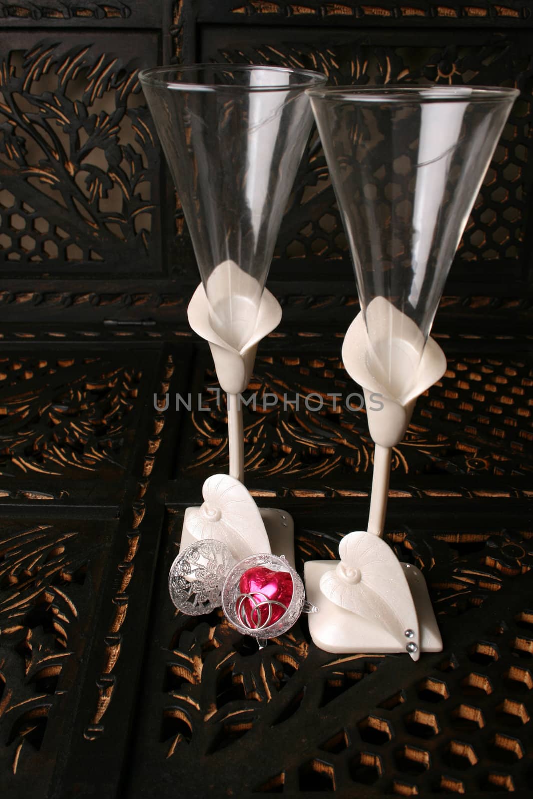 Decorated long stem glasses with a chocolate heart and rings