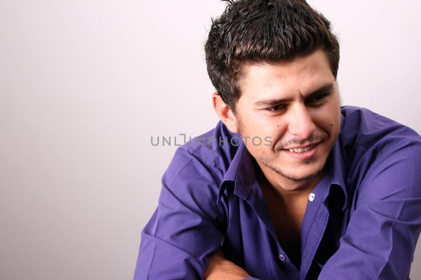 Male model in studio against white wall