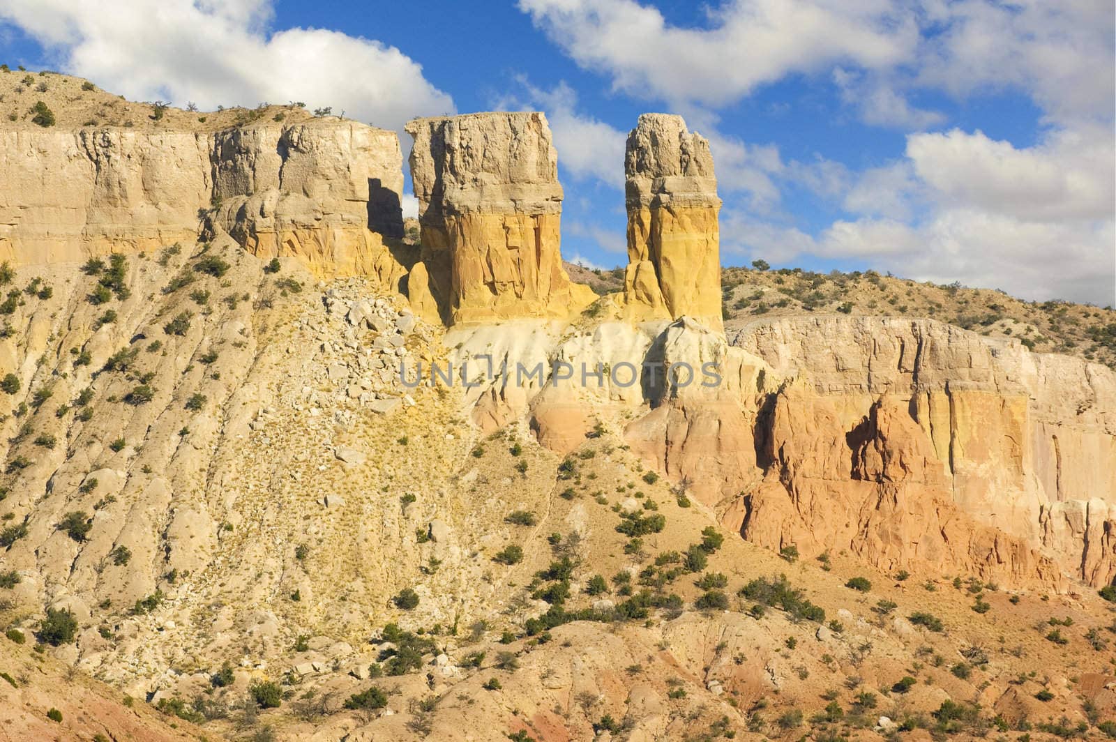 Sunset on the colorful layers of strata in the rock formations of a mesa in New Mexico