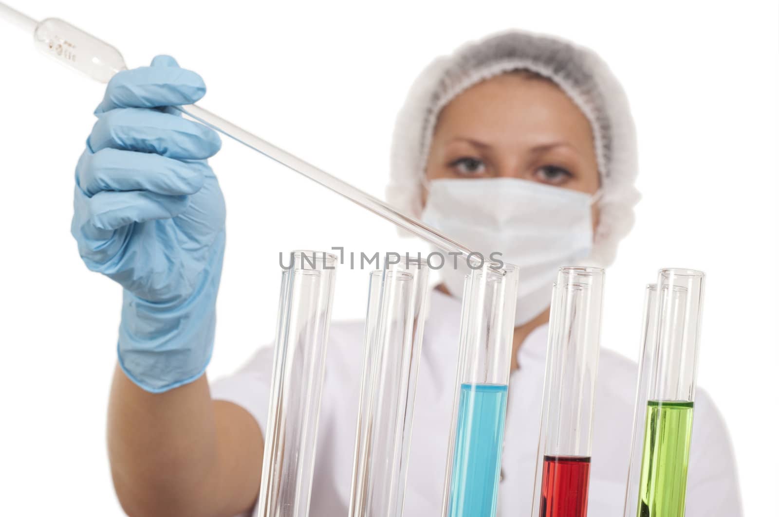 young woman scientist who mixes the liquid in the tubes