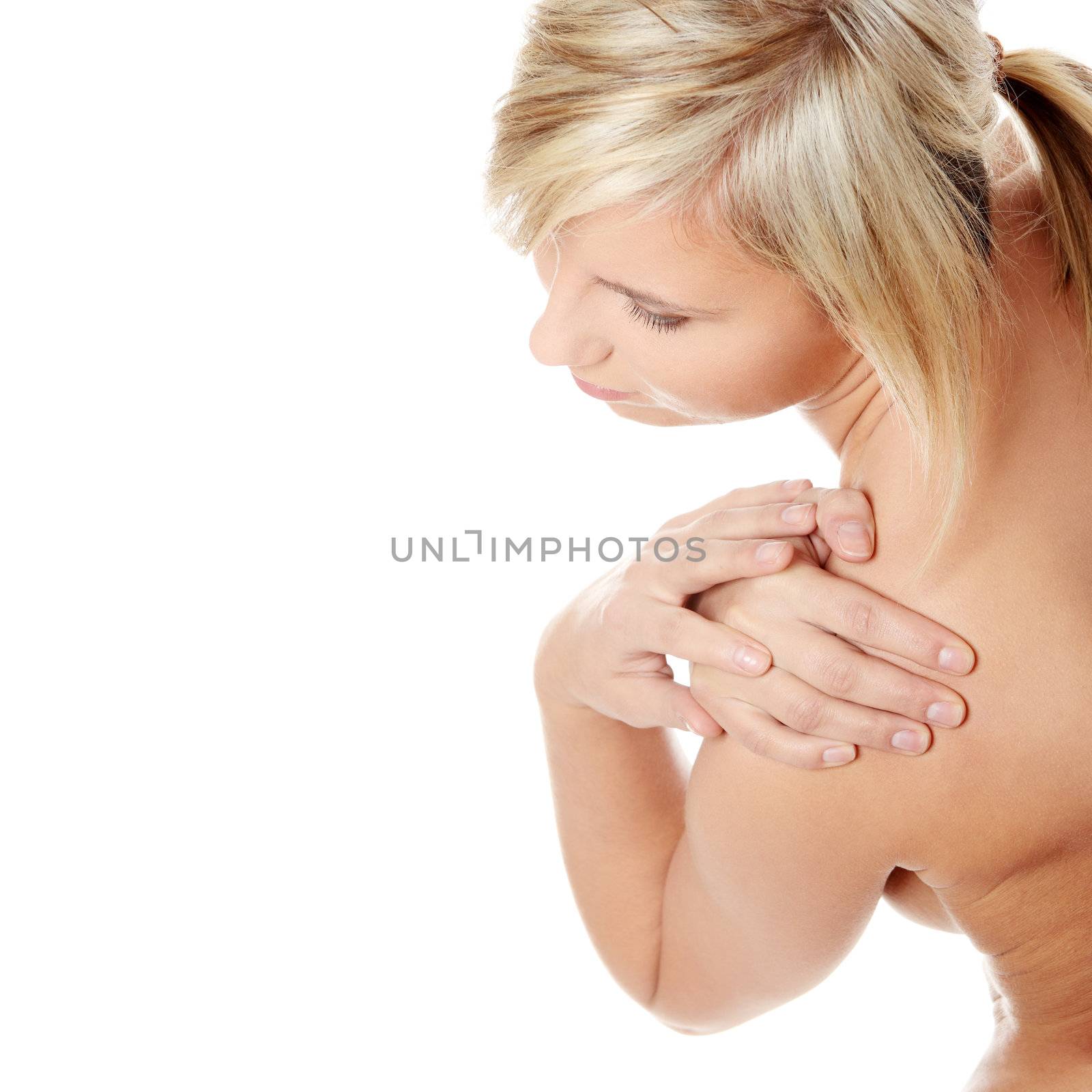 Woman massaging pain in her shoulder, isolated on white