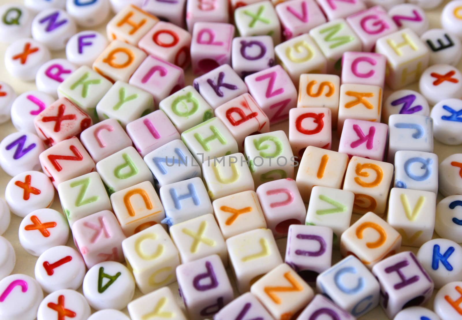 Small Colorful letters on different white shapes