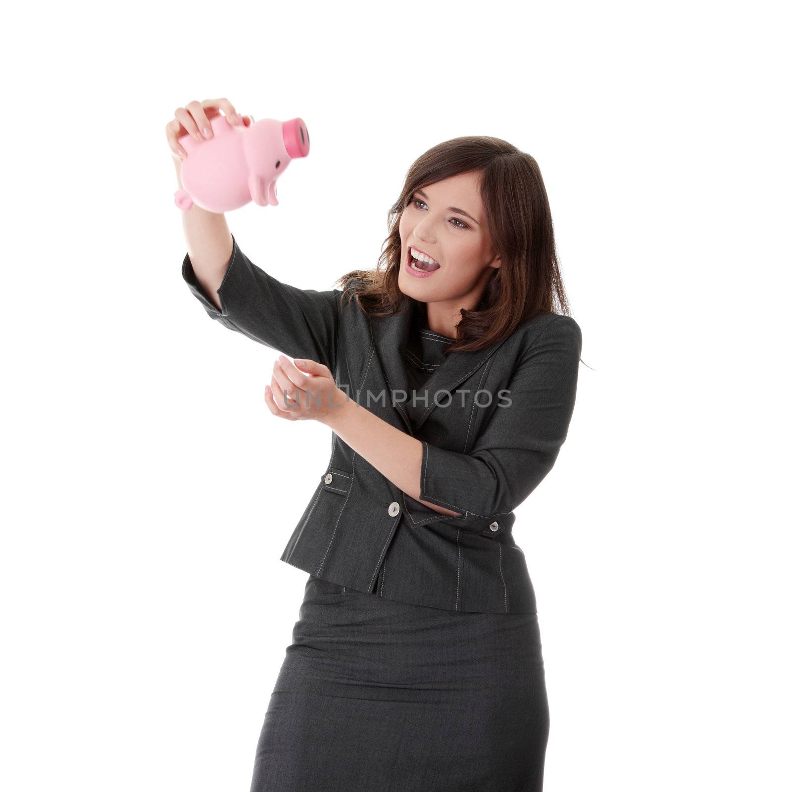 Savings concept - a woman with a piggy bank trying to get out some money - isolated over white