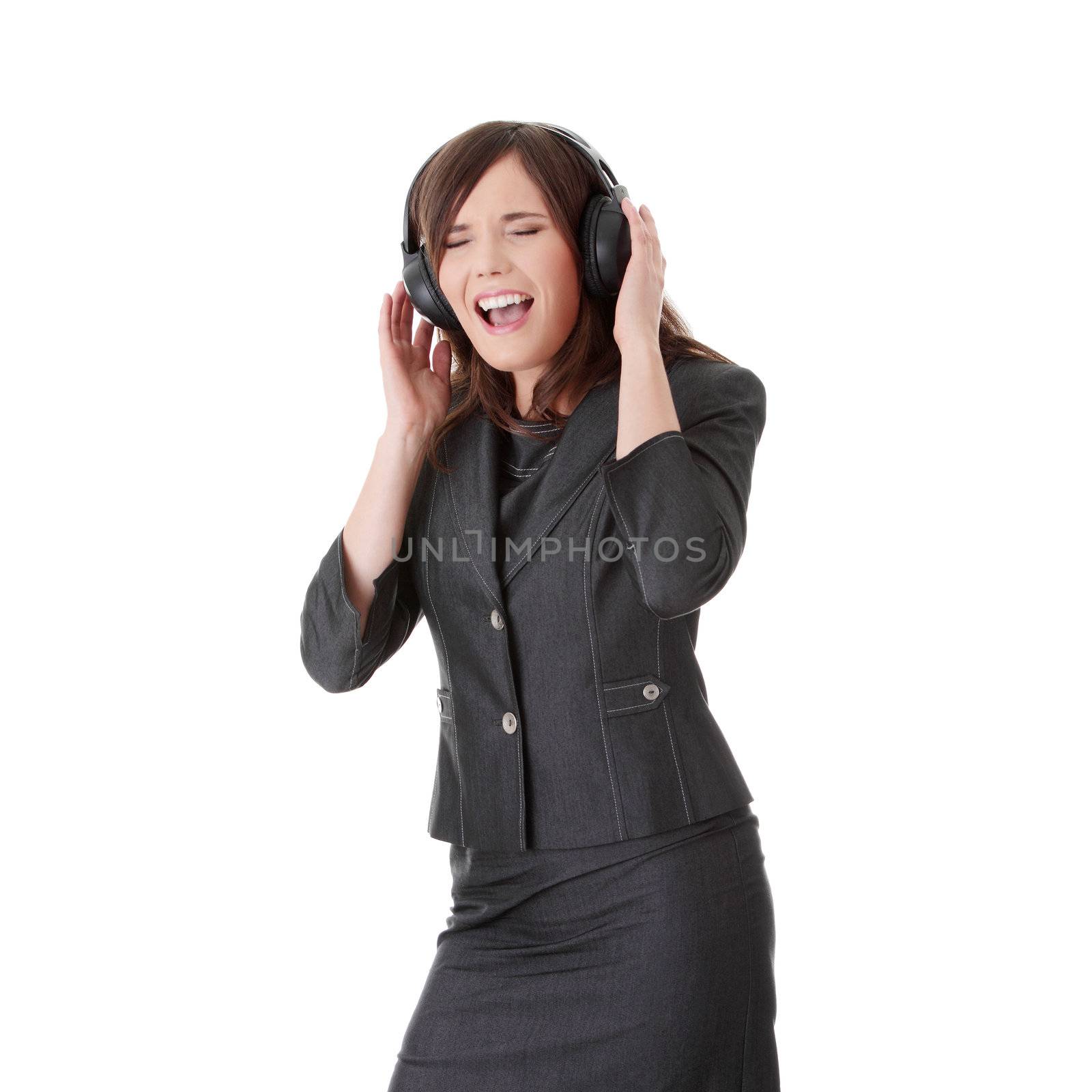 Young business woman listening music by headphone, isolated on white.