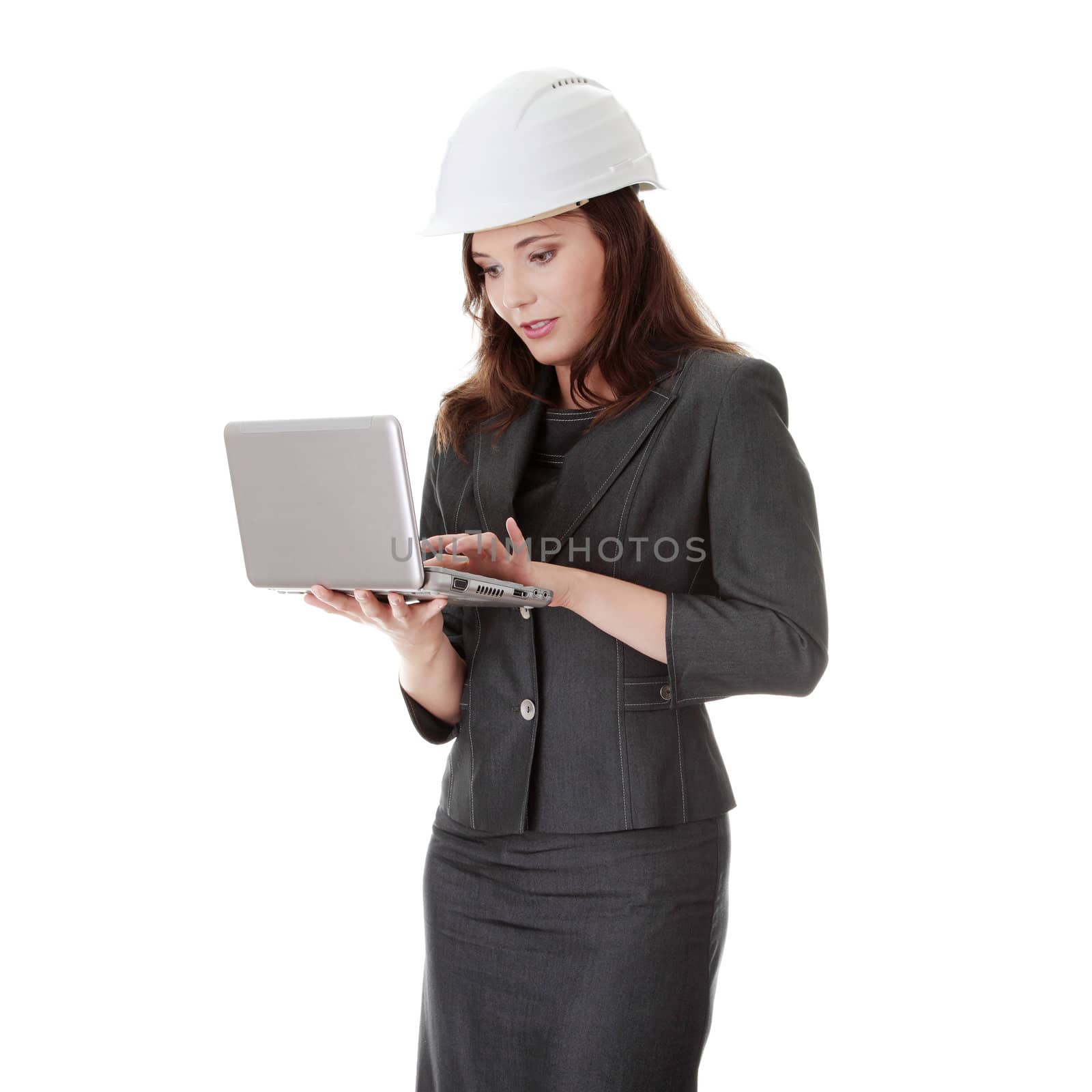 Smiling young female architect holding small laptop, isolated on white background