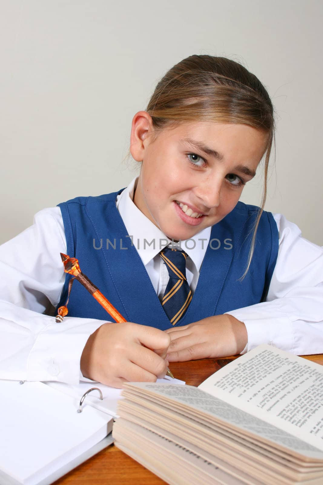 Teenage School girl busy with her homework, wearing uniform