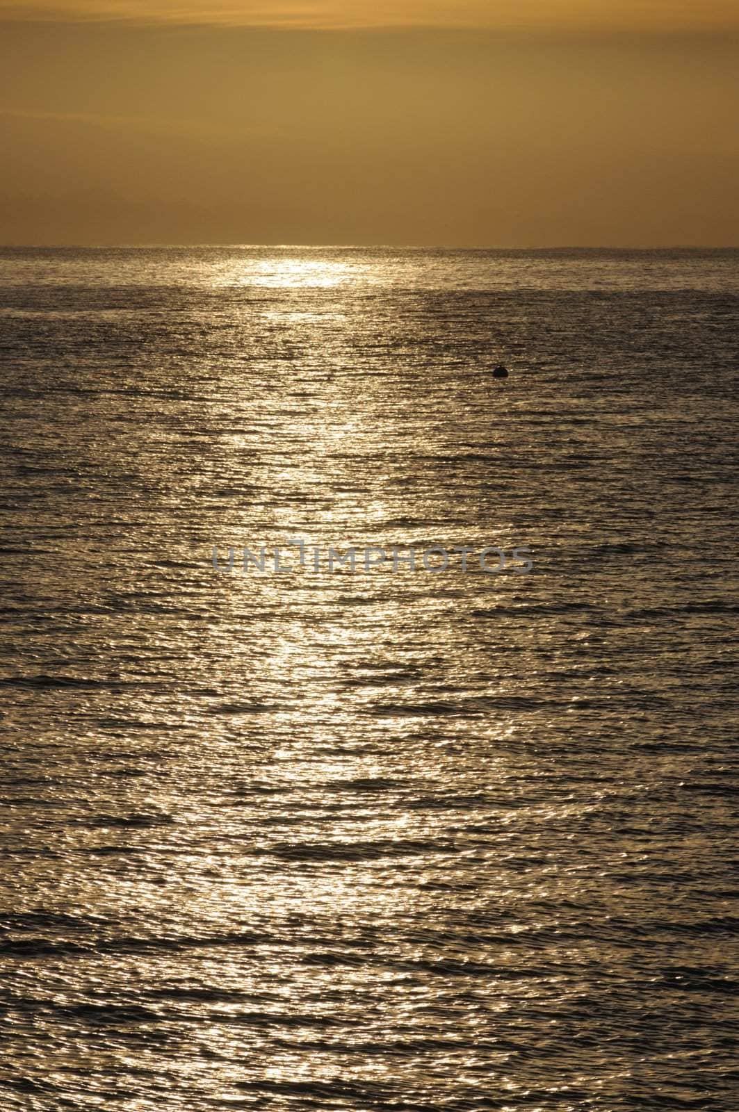 Sunrise reflecting on the water of the Pacific ocean in Maonterey bay.