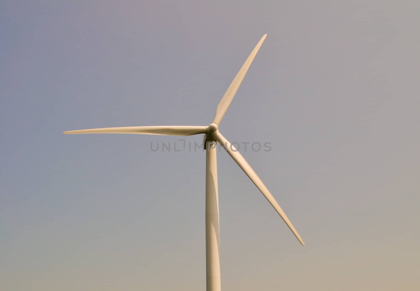 Wind turbine in blue sky by RefocusPhoto