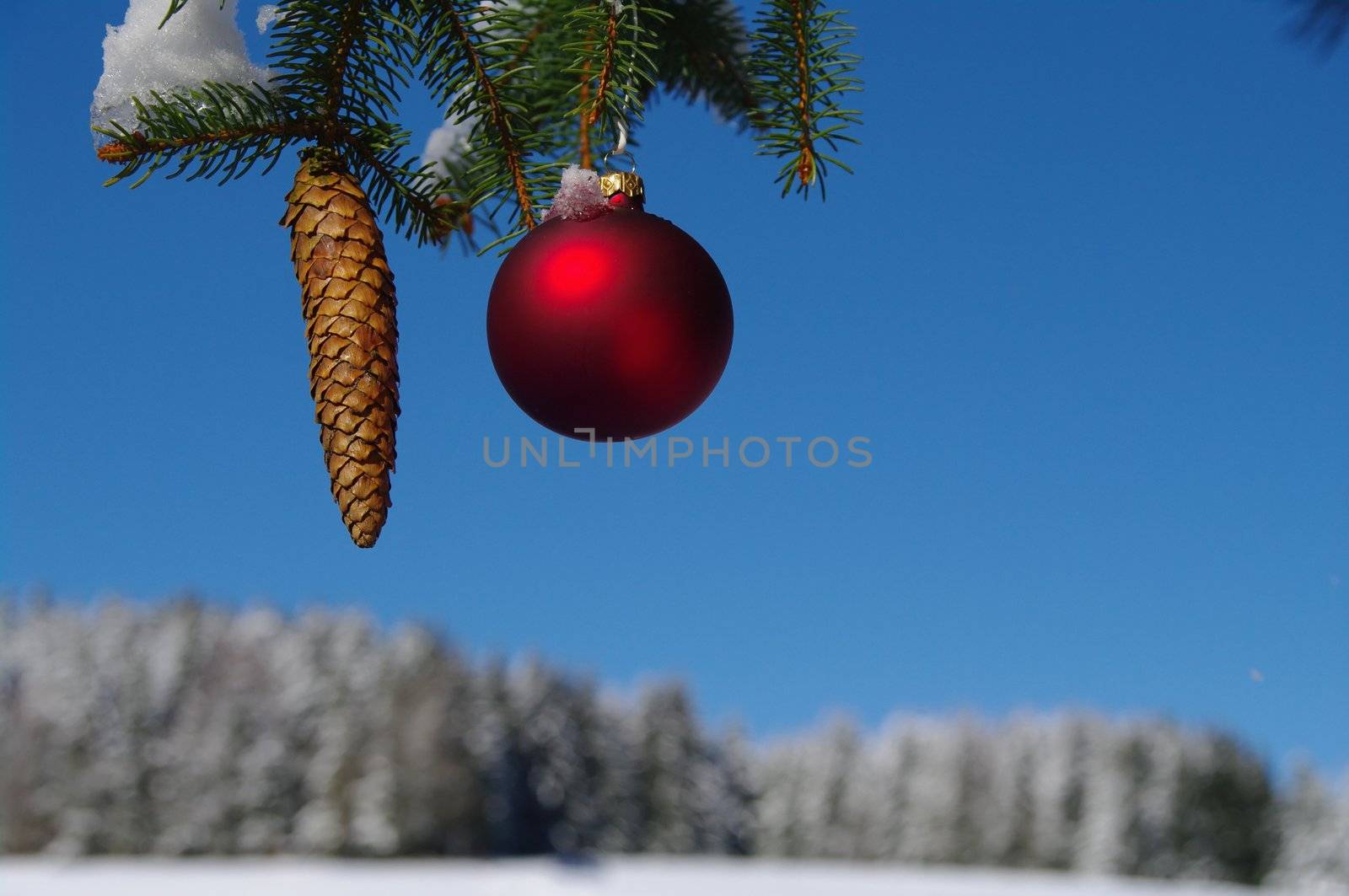 red bauble christmas ball ornament outside in a snowy winter scene