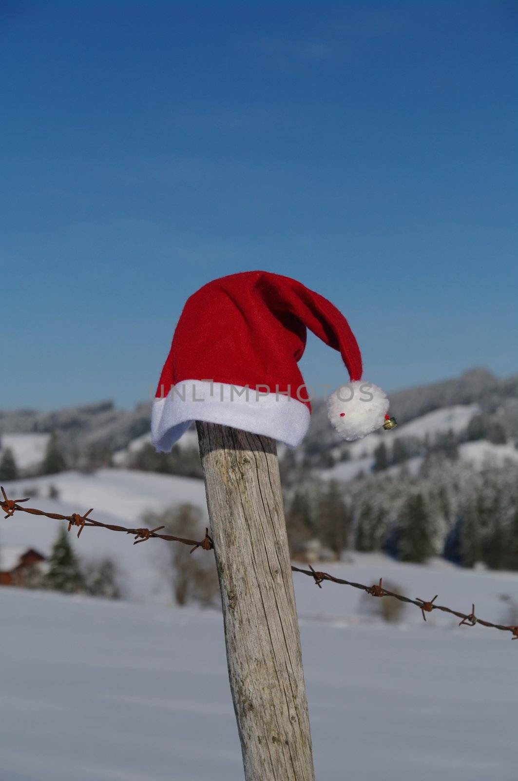 red santa claus hats in a snowy landscape