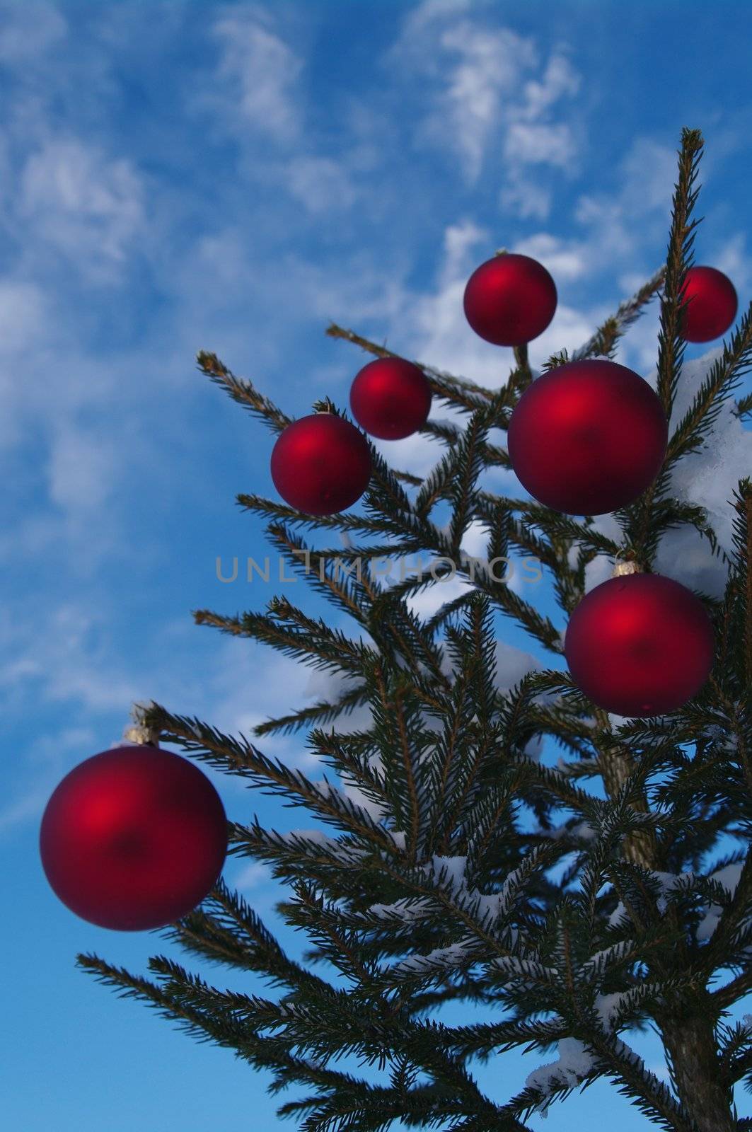 baubles  on a Christmas tree outside in a snowy landscape
