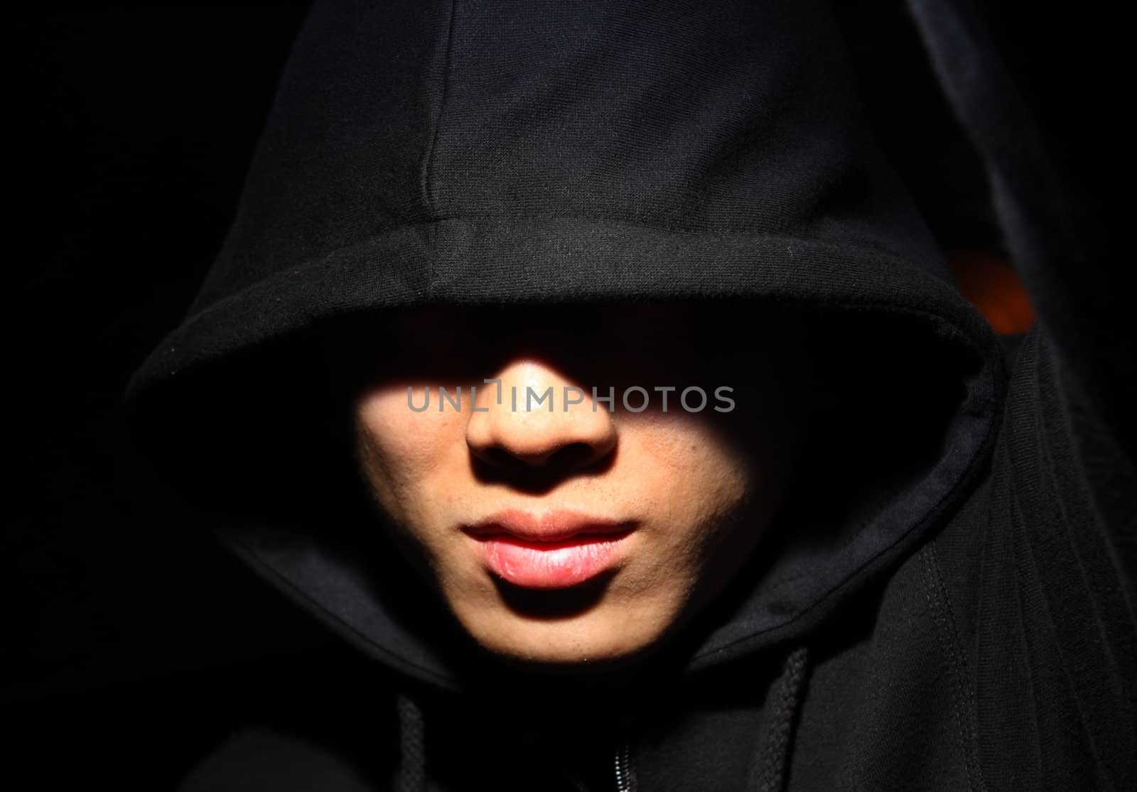 Monochrome picture of a guy in a hood 