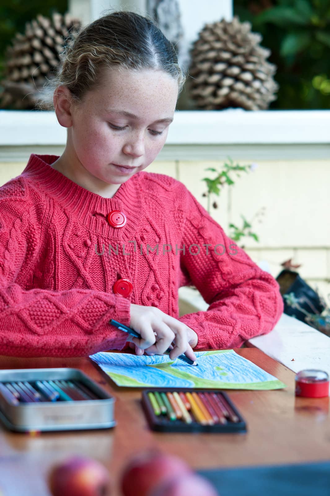 young girl drawing picture on front porch by rongreer