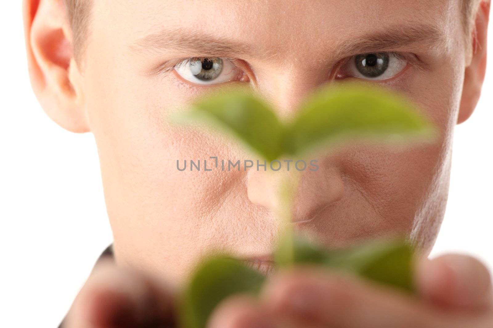 Businessman in dark suit holding smal plant in his hands - growth concept