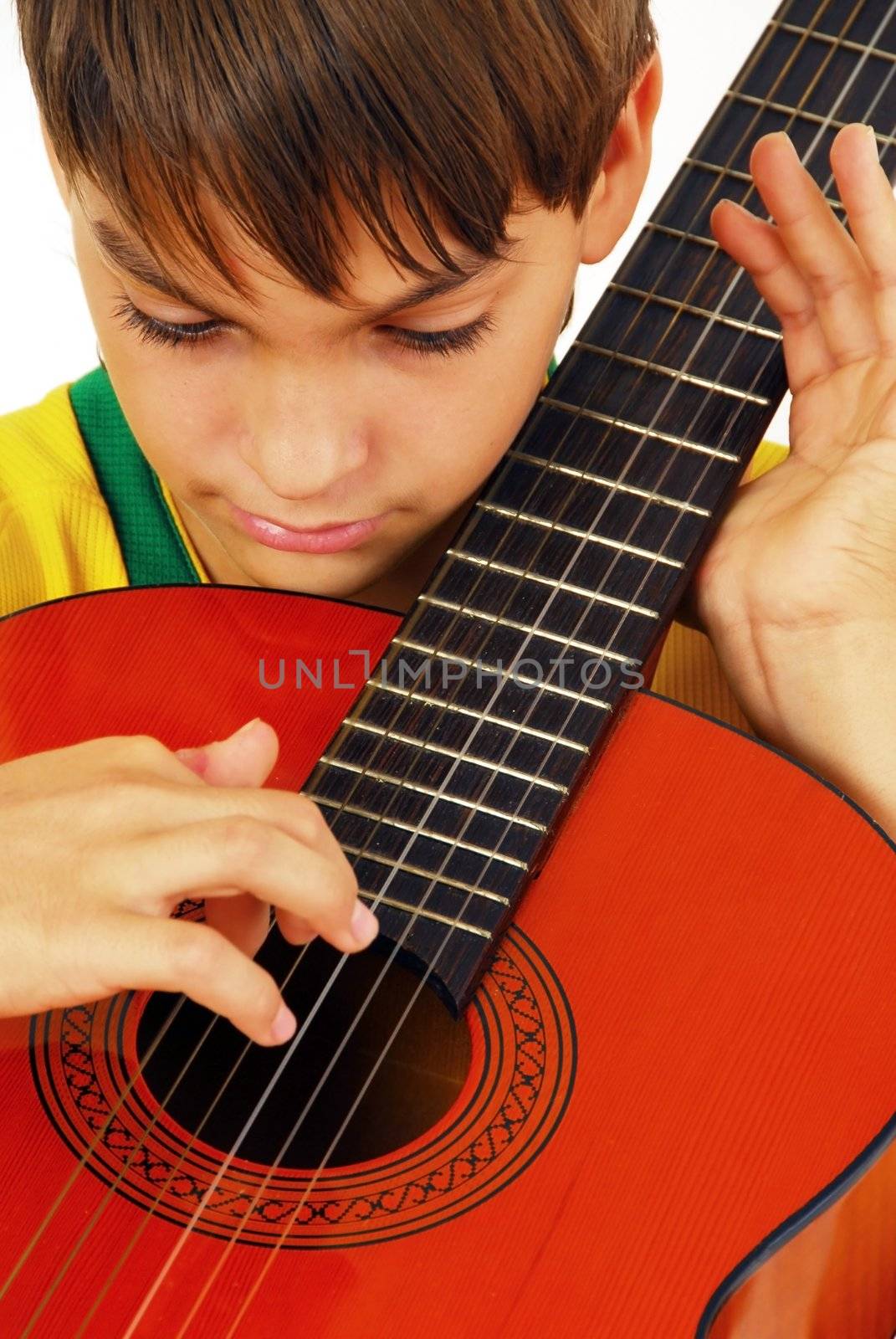 caucasian boy portrait with orange wooden guitar