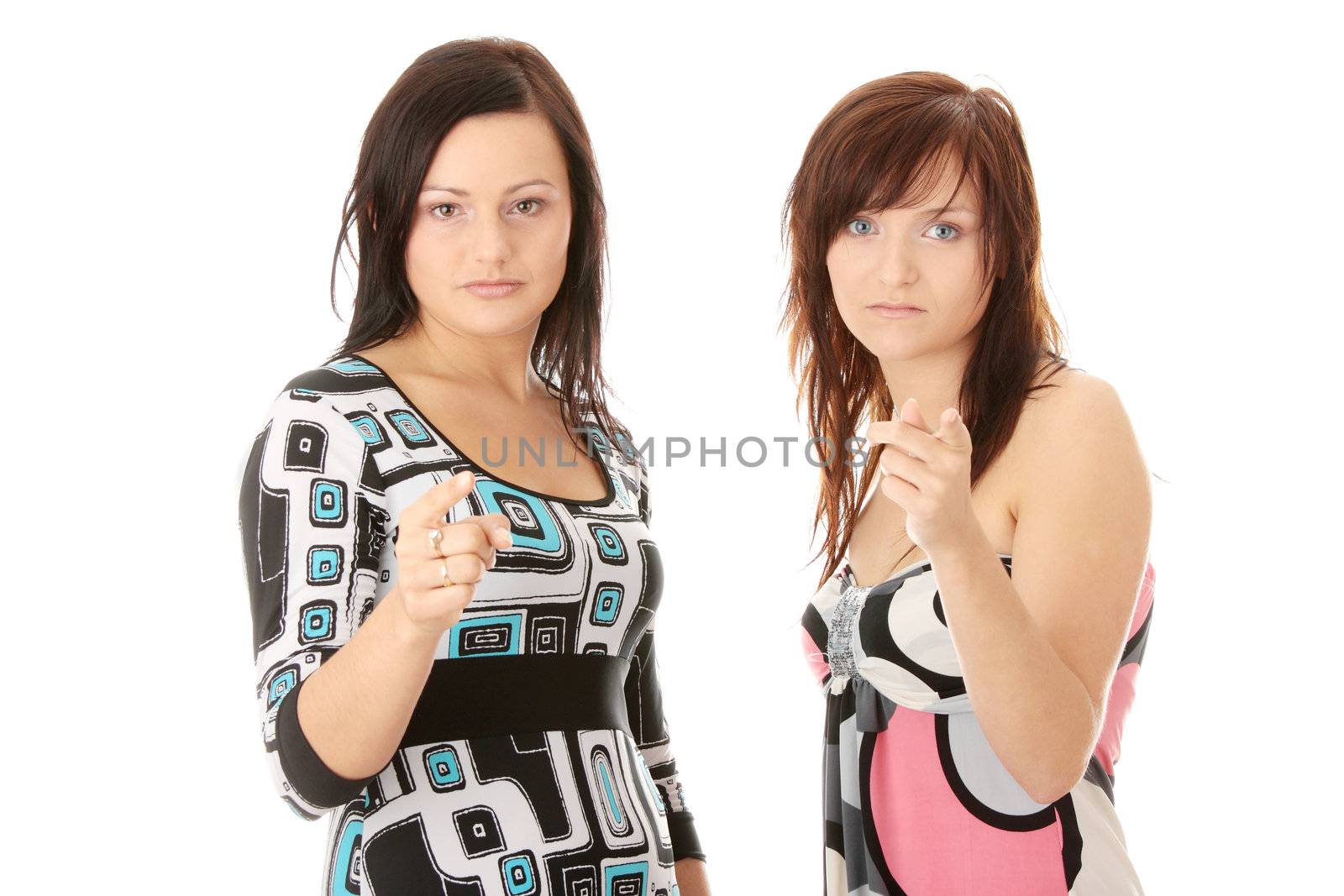 Two young womans pointing, isolated on white background