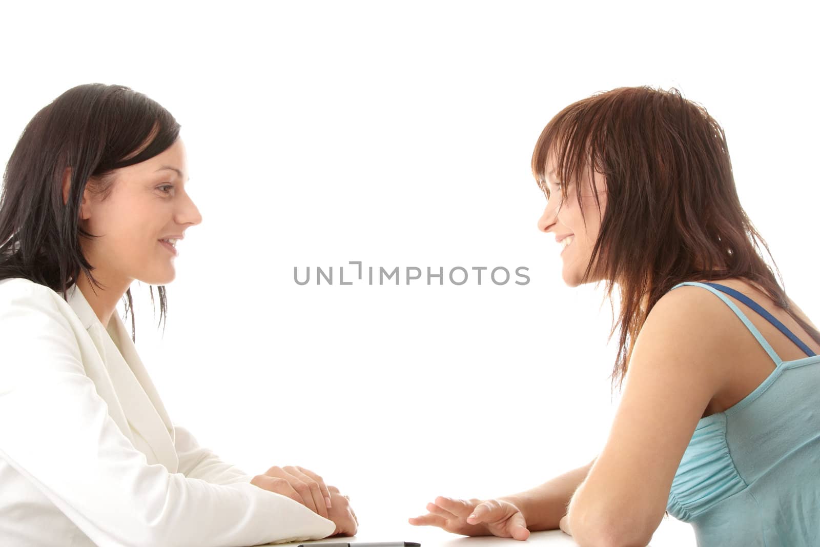 Happy young women friends talking. Isolated on white background