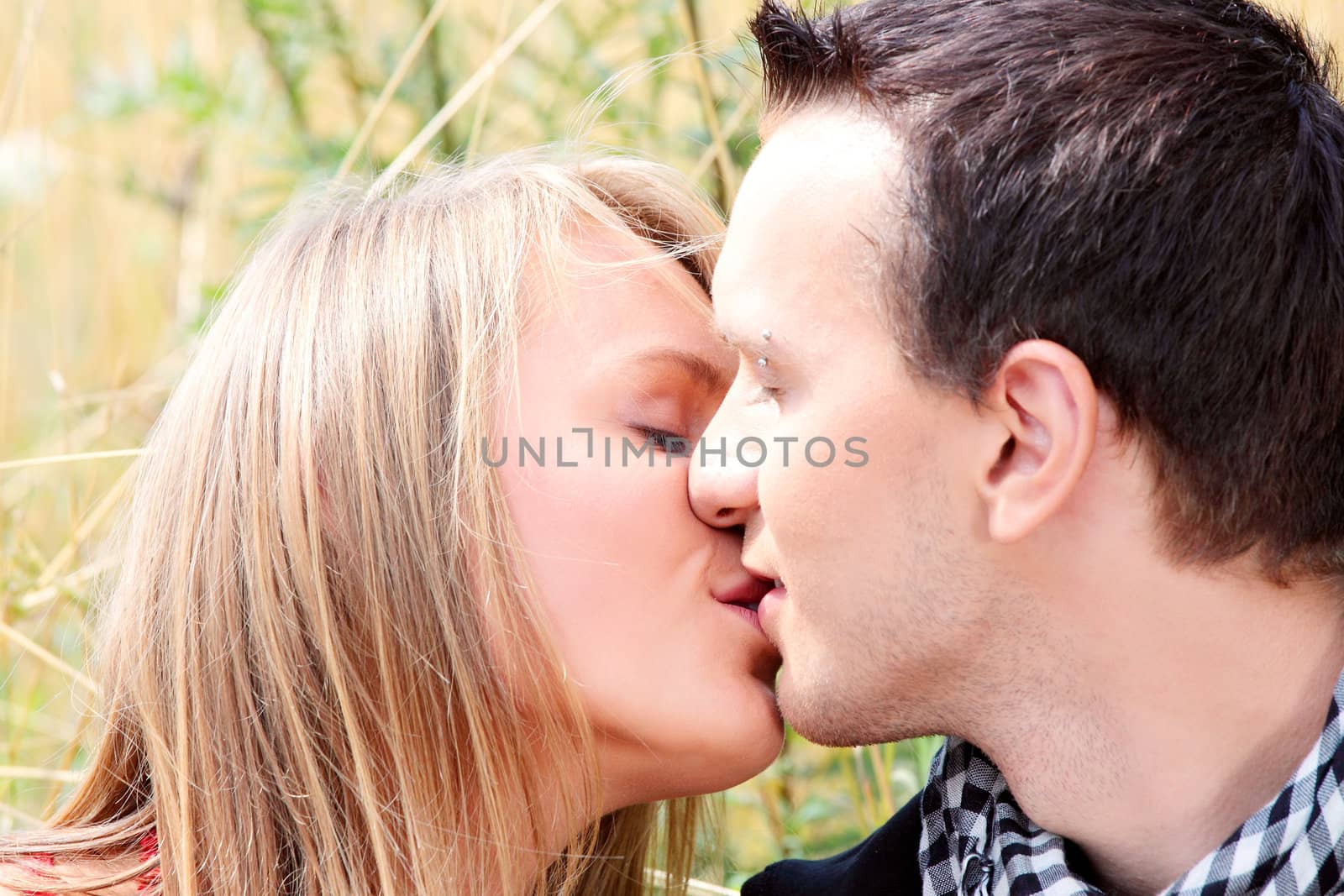 Young couple in grain field - kissing