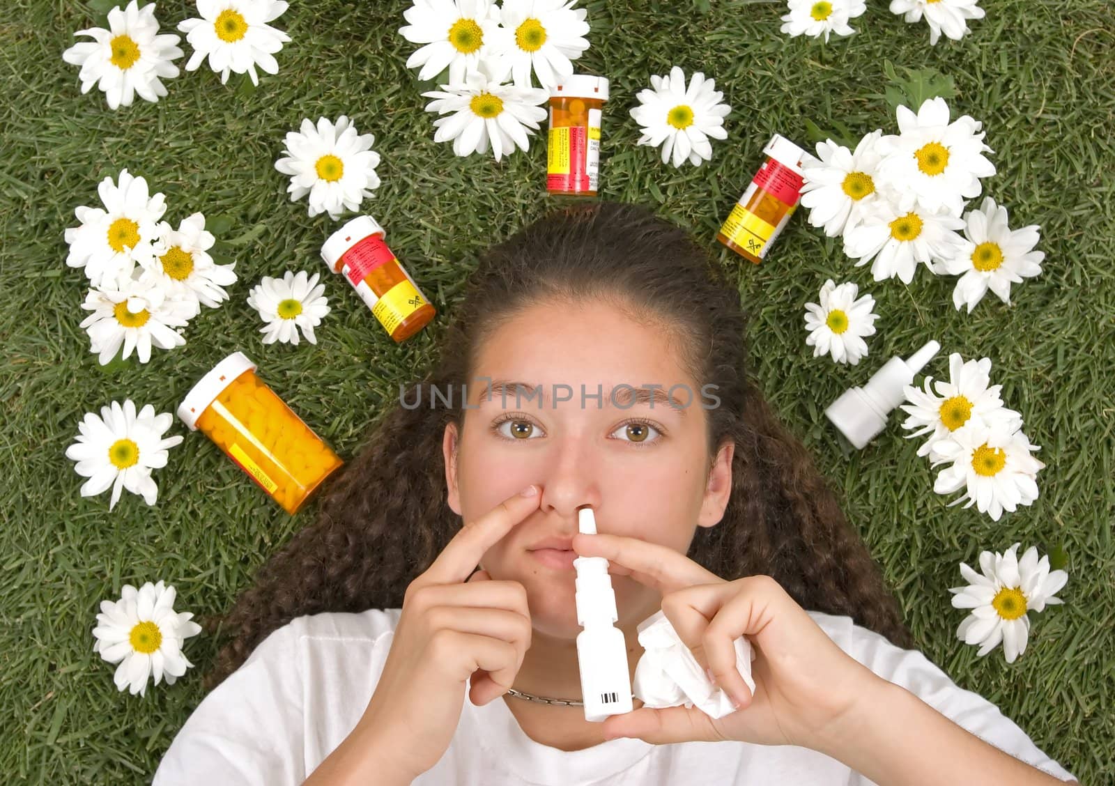 Teenage girl using nose spray for her pollen and grass allergies (Allergy relief)