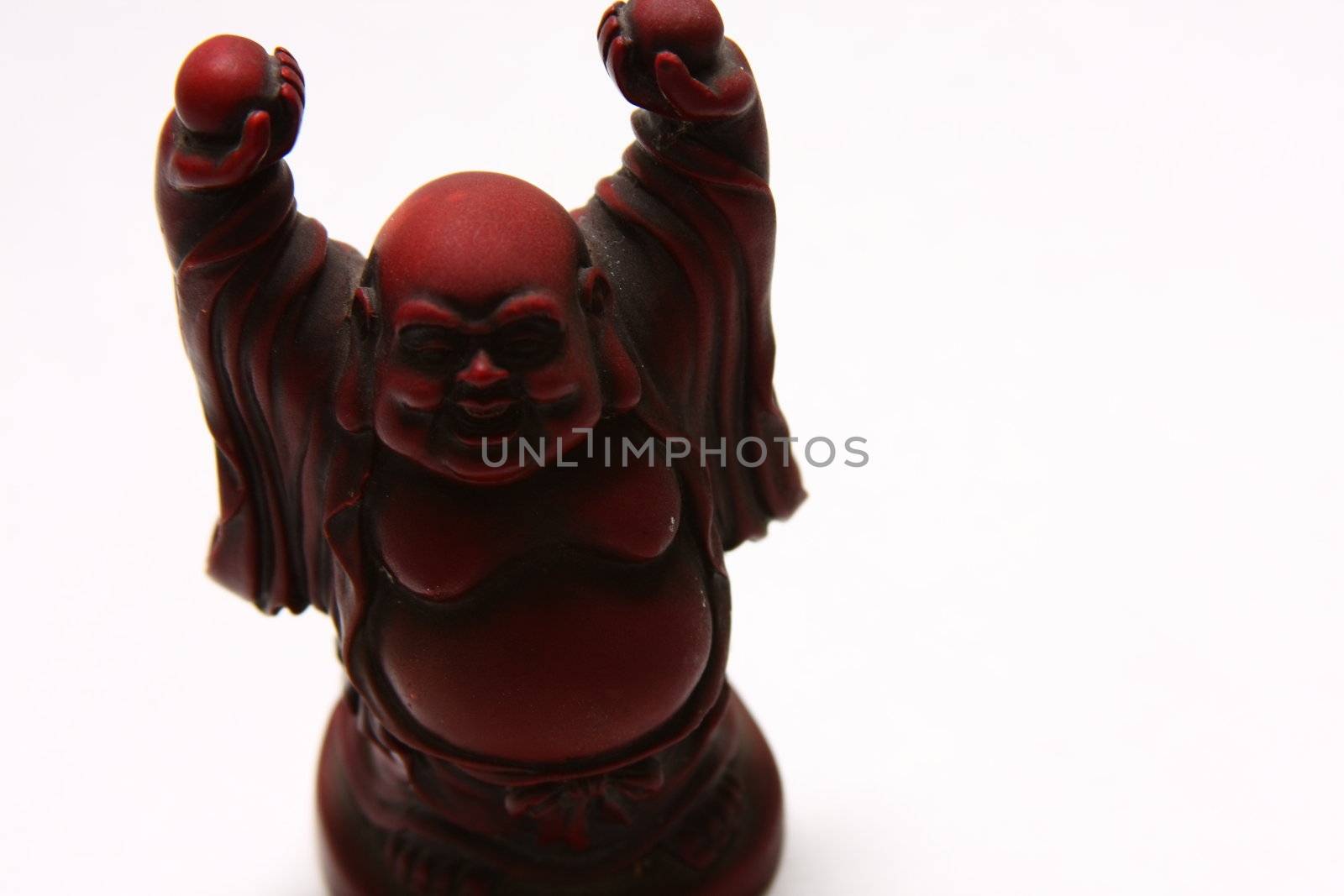 isolated shot of red buddha statue on white background