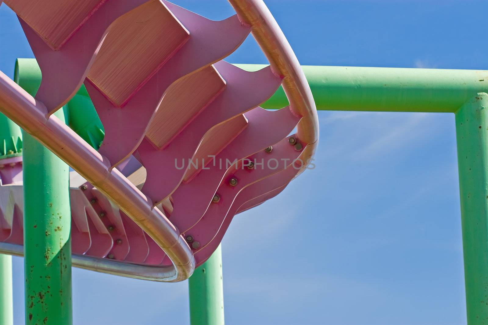 Rollercoaster track against a brilliant blue sky